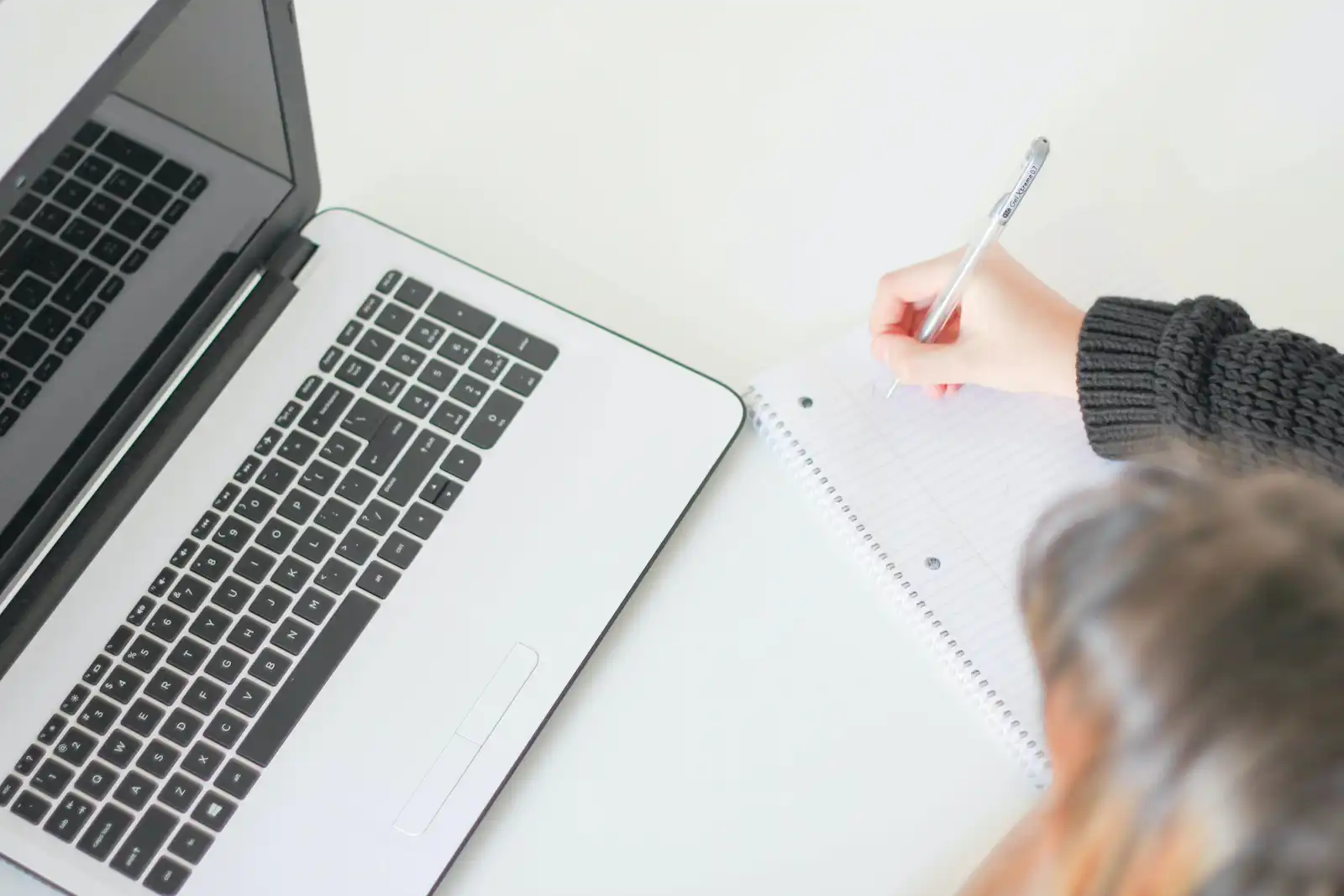 Shopify store owner reviewing product page SEO on laptop